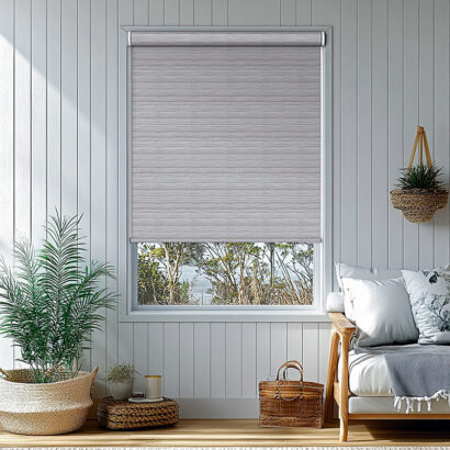 bright and airy living room features white roller blinds installed at window, allowing natural light to filter in. space is enhanced by greenery and cozy furnishings, creating serene atmosphere