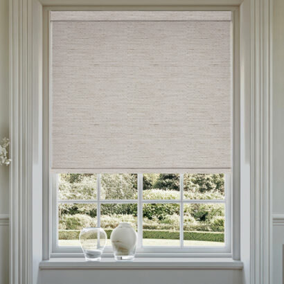 Grey roller blind in modern living room.